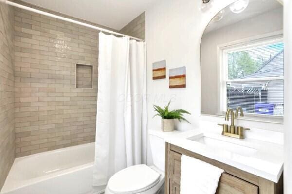 4502 Aragon Ave, Columbus, OH 43227 - bathroom featuring toilet, shower / bath combo, and vanity