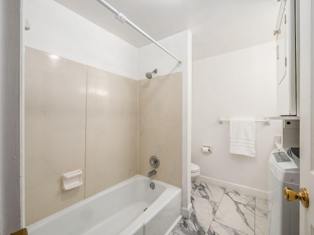 full bath with marble look tiles, toilet, baseboards, washtub / shower combination, and washing machine and dryer