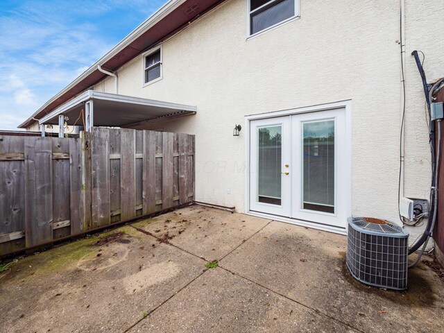 back of house with french doors, central air condition unit, stucco siding, a patio area, and fence