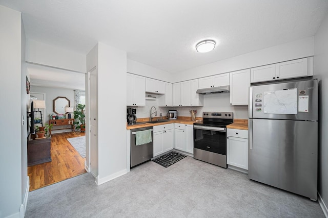 1779 Willoway Cir N, Columbus, OH 43220 - kitchen featuring appliances with stainless steel finishes, under cabinet range hood, wood counters, white cabinets, and light flooring