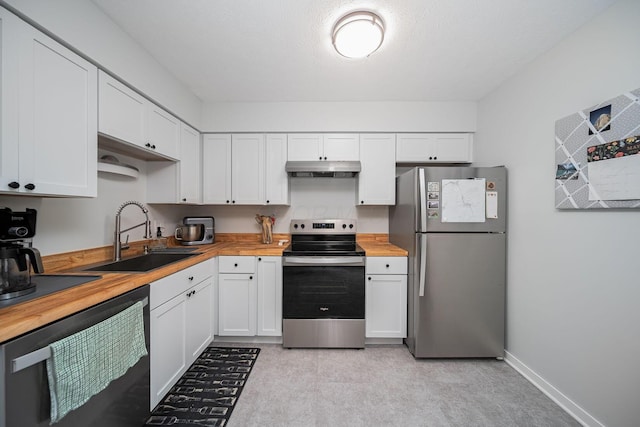 1779 Willoway Cir N, Columbus, OH 43220 - kitchen featuring appliances with stainless steel finishes, a sink, wood counters, under cabinet range hood, and white cabinets