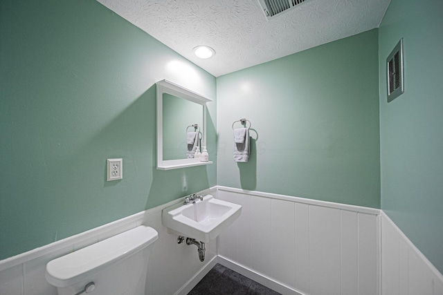 1779 Willoway Cir N, Columbus, OH 43220 - bathroom featuring toilet, a wainscoted wall, a textured ceiling, and a sink