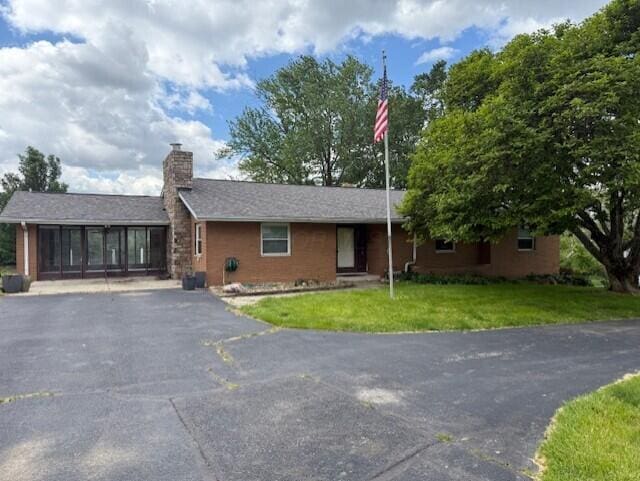 8165 Busey Rd, Pickerington, OH 43147 - ranch-style house with a chimney, driveway, and a front yard
