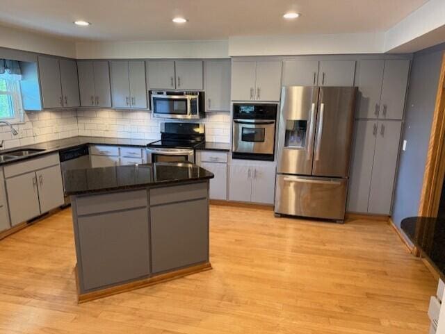 8165 Busey Rd, Pickerington, OH 43147 - kitchen featuring stainless steel appliances, gray cabinetry, light wood-style floors, decorative backsplash, and recessed lighting