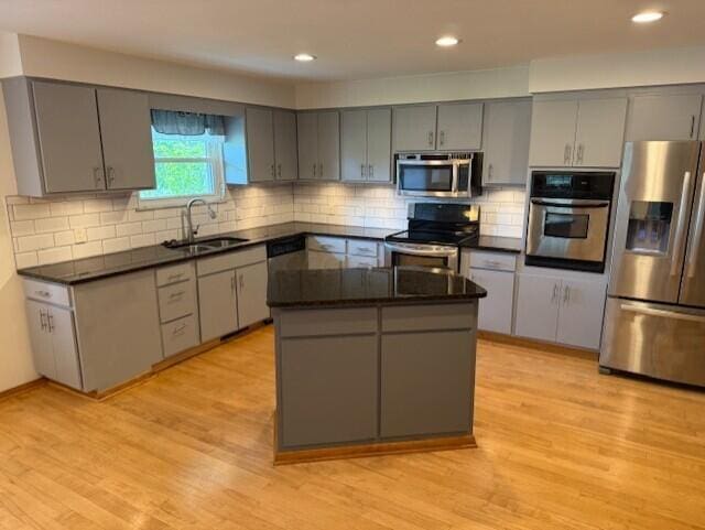 8165 Busey Rd, Pickerington, OH 43147 - kitchen featuring appliances with stainless steel finishes, a sink, gray cabinetry, light wood-type flooring, and recessed lighting