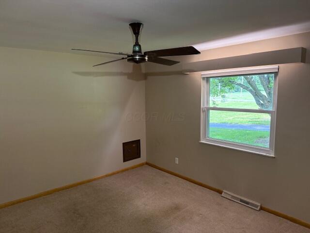 8165 Busey Rd, Pickerington, OH 43147 - spare room featuring light colored carpet, baseboards, and ceiling fan