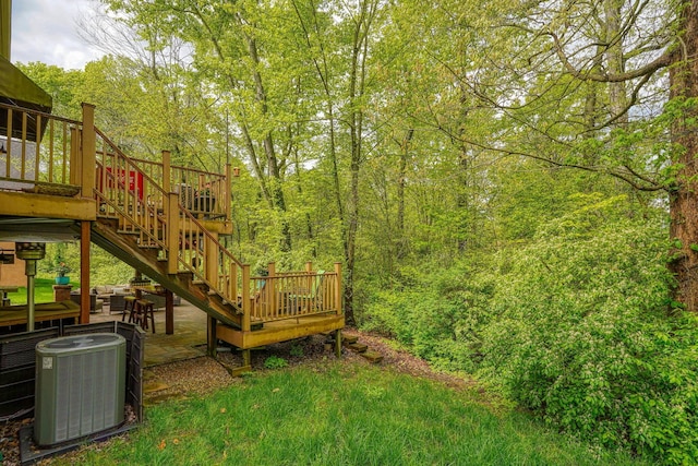 view of yard featuring stairs, cooling unit, and a wooden deck