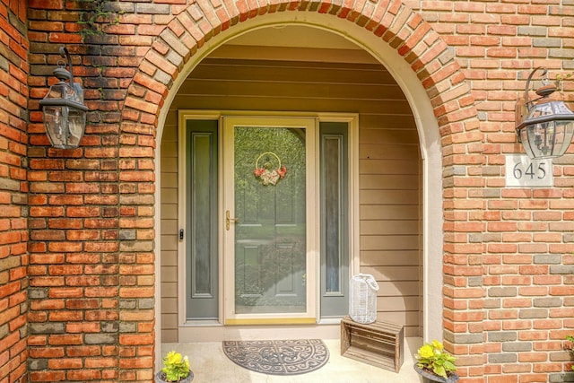 entrance to property with brick siding