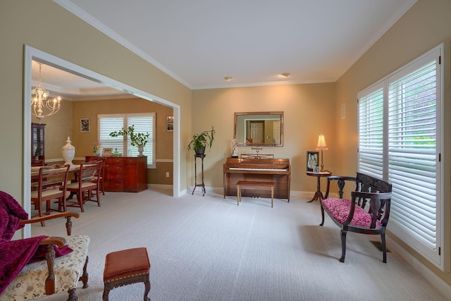 living area featuring a chandelier, ornamental molding, carpet floors, and baseboards
