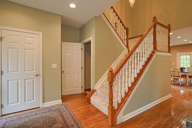 stairs featuring baseboards, recessed lighting, and hardwood / wood-style flooring