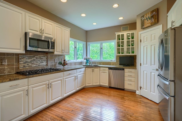 kitchen featuring light wood-style flooring, white cabinetry, and appliances with stainless steel finishes