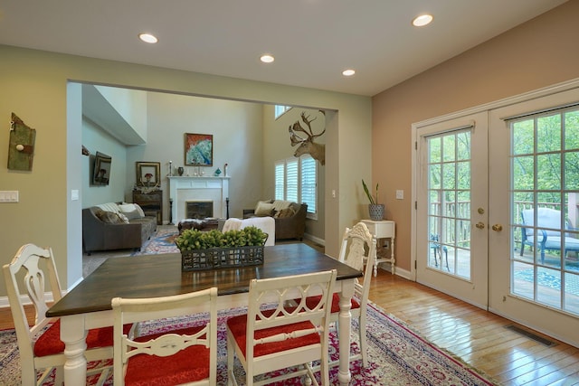 dining area with wood-type flooring, a fireplace, visible vents, baseboards, and recessed lighting