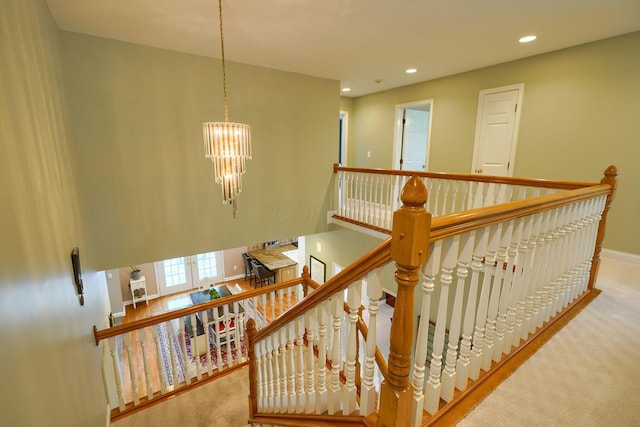 staircase with baseboards, a notable chandelier, recessed lighting, and carpet
