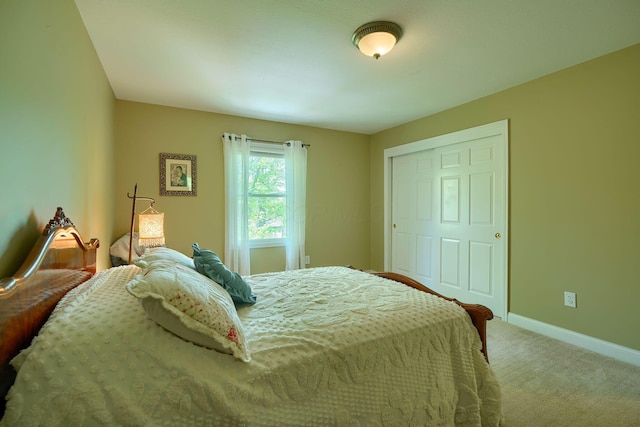 bedroom with baseboards and light carpet