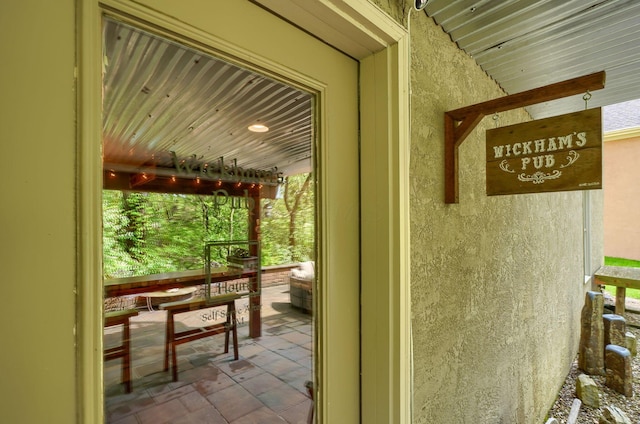 entrance to property featuring stucco siding