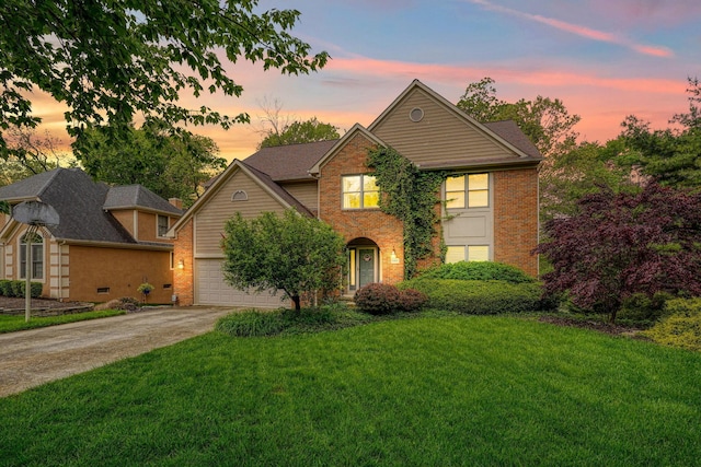 traditional-style home with a front yard, brick siding, and driveway