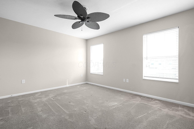 carpeted empty room with baseboards and ceiling fan