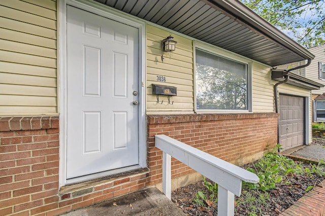 doorway to property featuring brick siding