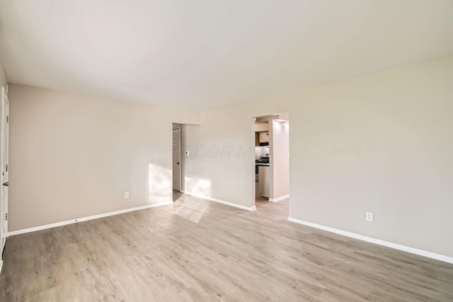 unfurnished room featuring light wood-style floors and baseboards