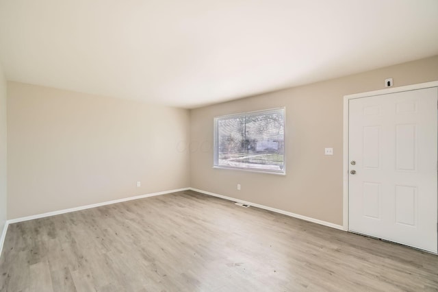 unfurnished room featuring wood finished floors and baseboards