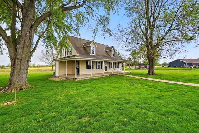 country-style home featuring a front yard and covered porch