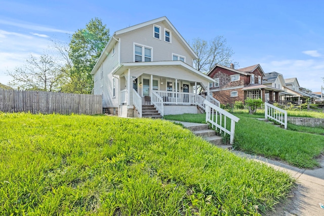 traditional style home with covered porch, fence, and stairway