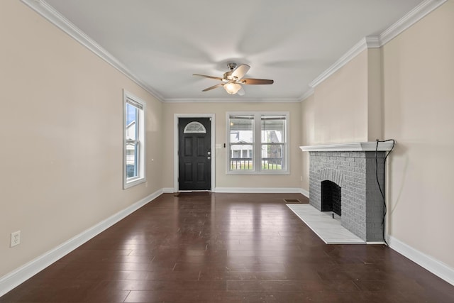 unfurnished living room with healthy amount of natural light, ceiling fan, crown molding, a fireplace, and wood finished floors