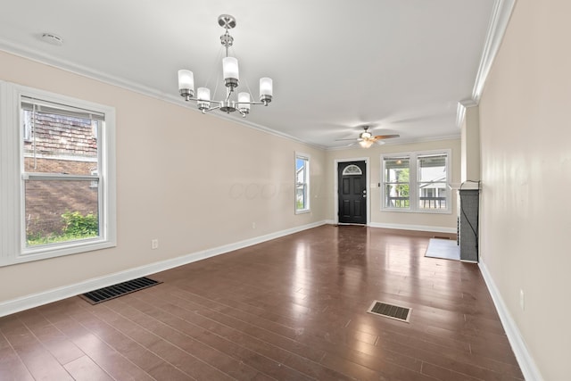 unfurnished living room with ornamental molding, a chandelier, a ceiling fan, baseboards, and dark wood-style flooring