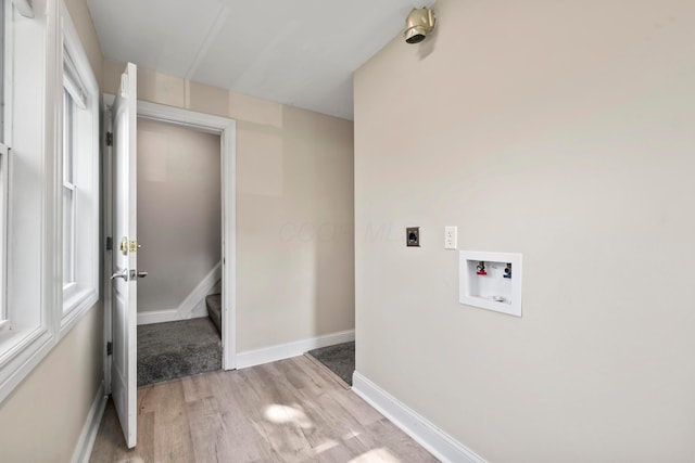 washroom with hookup for an electric dryer, washer hookup, light wood-type flooring, and baseboards
