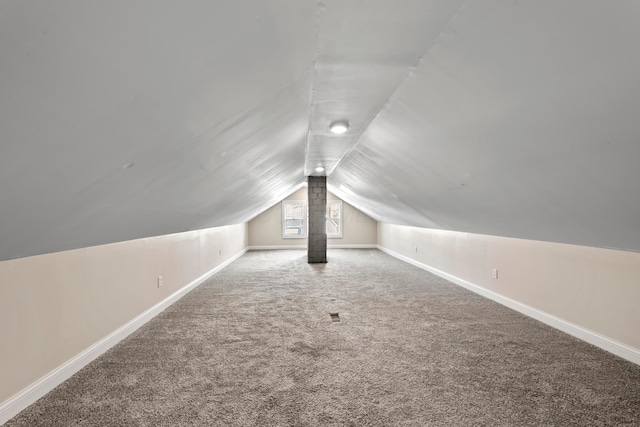 bonus room with carpet floors, baseboards, and lofted ceiling