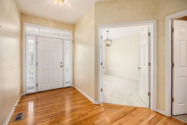 entrance foyer with light wood finished floors and baseboards