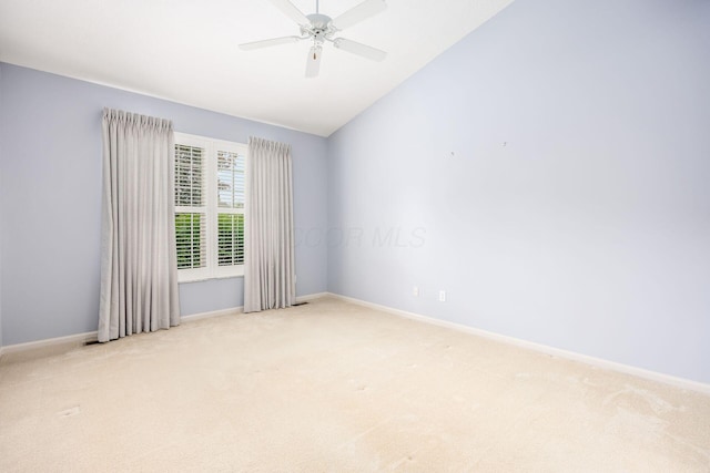 unfurnished room featuring light carpet, lofted ceiling, baseboards, and a ceiling fan