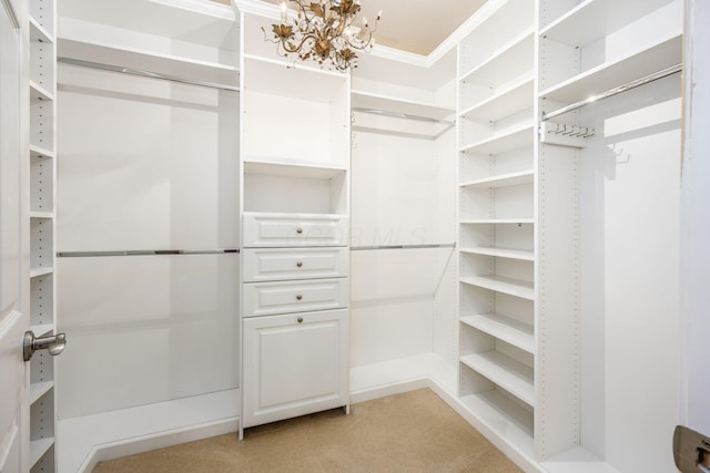 spacious closet featuring light colored carpet and a chandelier