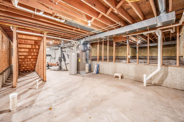 unfinished below grade area featuring heating unit and gas water heater