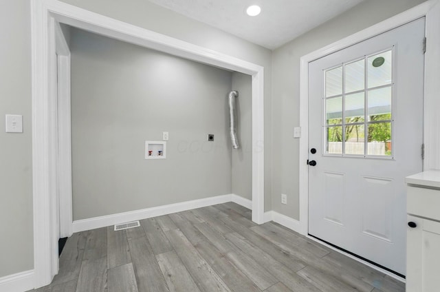 laundry area featuring wood finished floors, hookup for a washing machine, baseboards, and electric dryer hookup