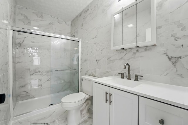 full bathroom with tile walls, toilet, a marble finish shower, and vanity