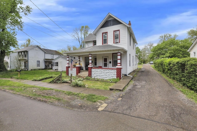 233-235 N 13th St, Newark, OH 43055 - view of front of home featuring covered porch, a chimney, and driveway