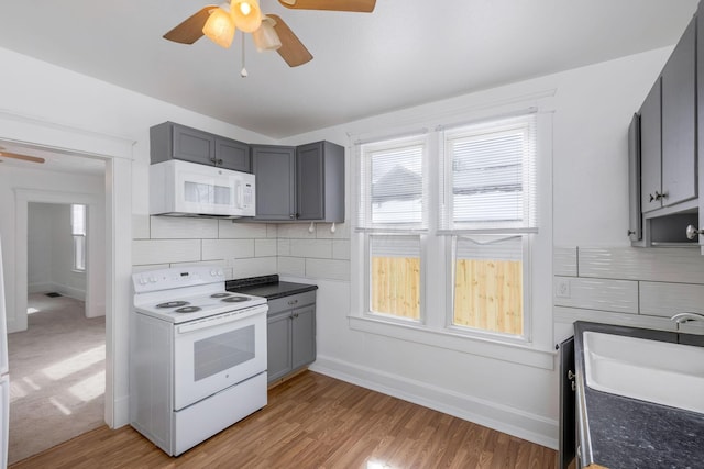 233-235 N 13th St, Newark, OH 43055 - kitchen with white appliances, ceiling fan, a sink, gray cabinetry, and backsplash