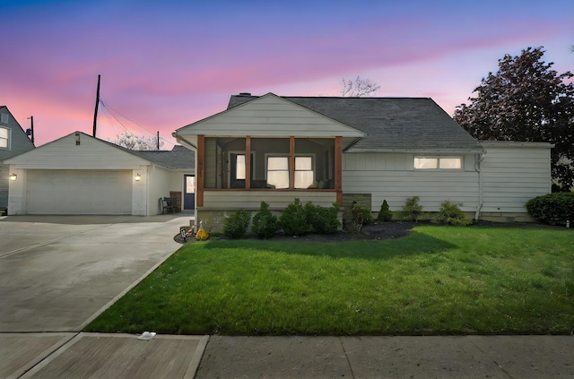 591 French Dr, Columbus, OH 43228 - view of front of home with a front lawn, driveway, an attached garage, and a sunroom