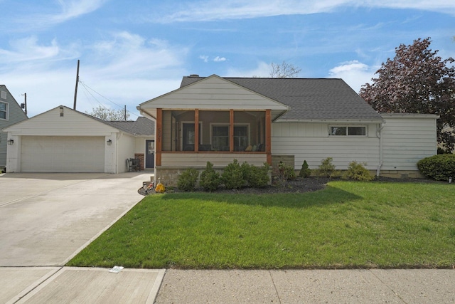 591 French Dr, Columbus, OH 43228 - view of front of property featuring a front lawn, a sunroom, concrete driveway, and a shingled roof
