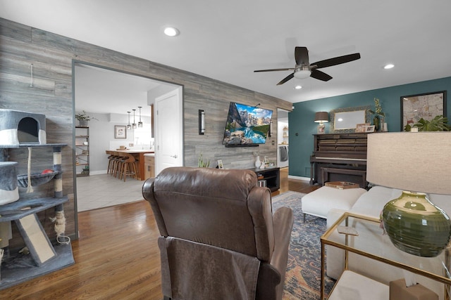 591 French Dr, Columbus, OH 43228 - living room featuring an accent wall, ceiling fan, wooden walls, baseboards, and recessed lighting