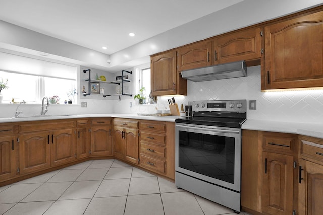591 French Dr, Columbus, OH 43228 - kitchen featuring stainless steel electric range, under cabinet range hood, a sink, brown cabinets, and light countertops