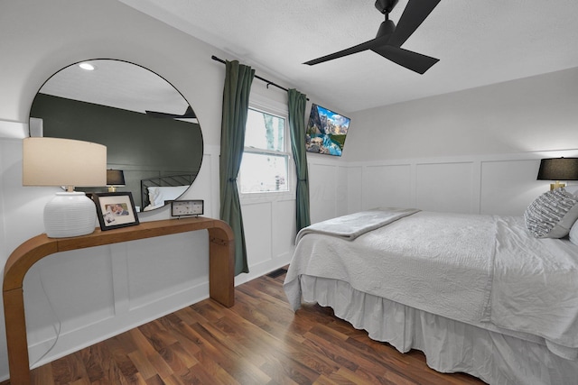 591 French Dr, Columbus, OH 43228 - bedroom with wood finished floors, wainscoting, a decorative wall, and a ceiling fan