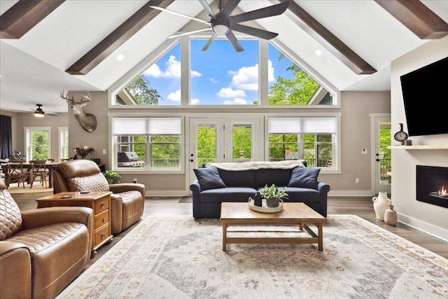 659 Natchez Ln, Sugar Grove, OH 43155 - living room featuring a ceiling fan, high vaulted ceiling, baseboards, beam ceiling, and a lit fireplace