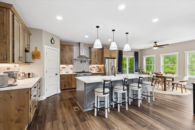 659 Natchez Ln, Sugar Grove, OH 43155 - kitchen with wall chimney exhaust hood, freestanding refrigerator, dark wood-style floors, light countertops, and brown cabinets
