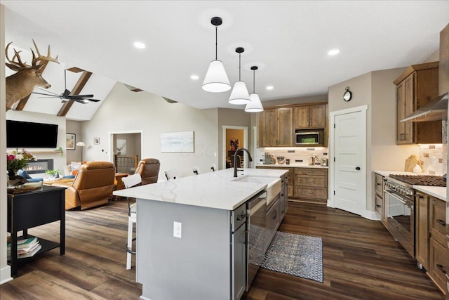 659 Natchez Ln, Sugar Grove, OH 43155 - kitchen with stainless steel appliances, a sink, backsplash, brown cabinets, and a center island with sink