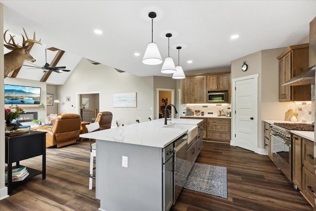 659 Natchez Ln, Sugar Grove, OH 43155 - kitchen featuring stainless steel appliances, a sink, tasteful backsplash, brown cabinetry, and a kitchen island with sink