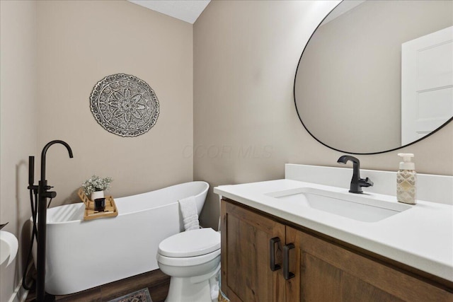 659 Natchez Ln, Sugar Grove, OH 43155 - full bathroom featuring vanity, a freestanding tub, toilet, and wood finished floors