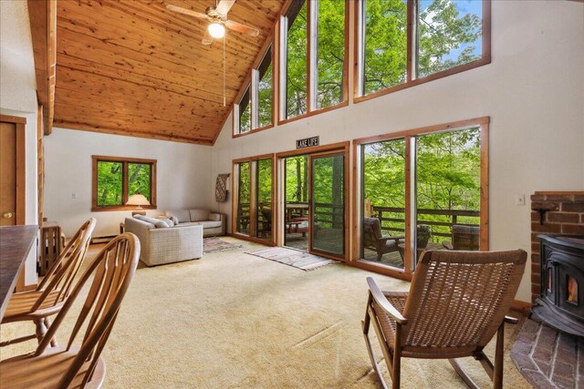 259 Shawnee Ln Unit L, Sugar Grove, OH 43155 - carpeted living area featuring high vaulted ceiling, a wood stove, wooden ceiling, and a ceiling fan