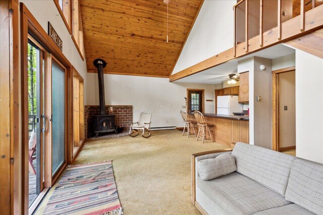 259 Shawnee Ln Unit L, Sugar Grove, OH 43155 - living area with carpet floors, a wood stove, high vaulted ceiling, wood ceiling, and ceiling fan